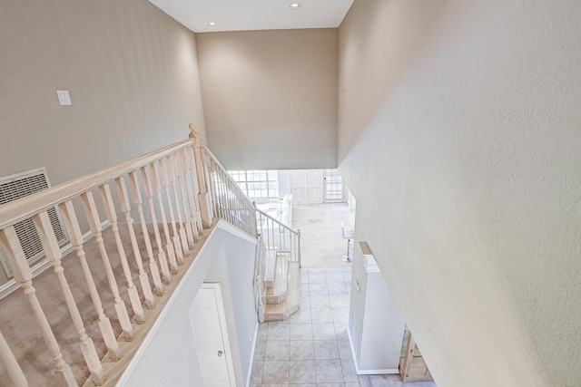 stairway featuring tile patterned flooring