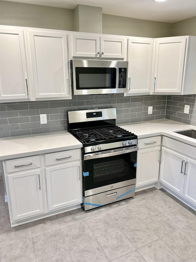 kitchen with tasteful backsplash, white cabinetry, and stainless steel appliances