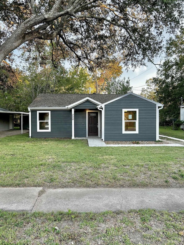 ranch-style home featuring a front yard