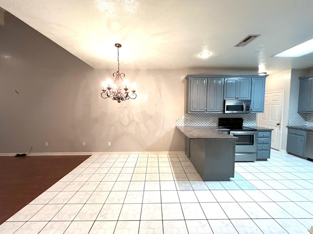 kitchen featuring tasteful backsplash, an inviting chandelier, pendant lighting, and appliances with stainless steel finishes