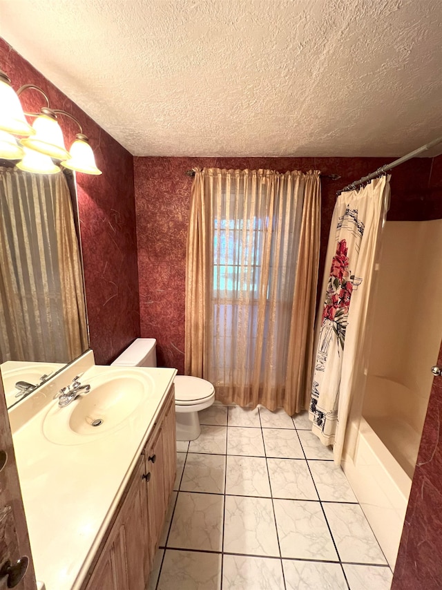 bathroom featuring toilet, vanity, a textured ceiling, and a shower with shower curtain