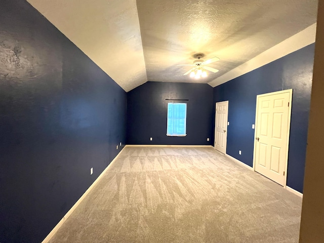 bonus room with vaulted ceiling, ceiling fan, light colored carpet, and a textured ceiling