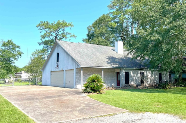 view of front of home with a front yard and a garage