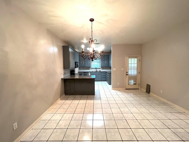 kitchen with backsplash, an inviting chandelier, sink, hanging light fixtures, and light tile patterned flooring