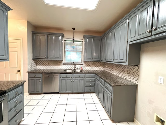 kitchen featuring gray cabinetry, dishwasher, sink, light tile patterned floors, and decorative light fixtures