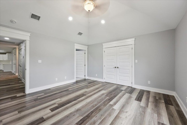 8679 Massey Lake Rd, Silsbee, TX 77656 - unfurnished bedroom featuring wood finished floors, a closet, vaulted ceiling, and recessed lighting
