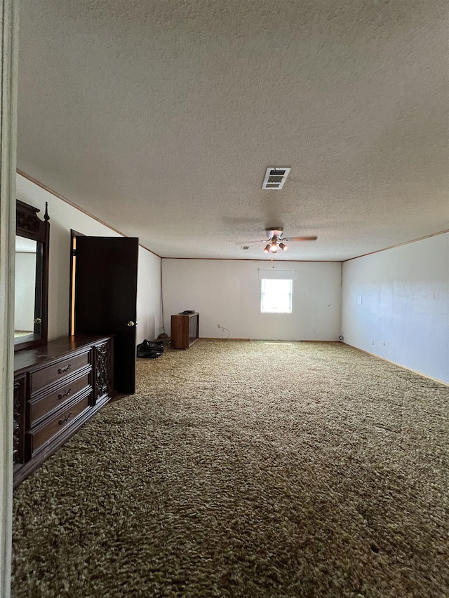 spare room with carpet flooring, a textured ceiling, and a ceiling fan