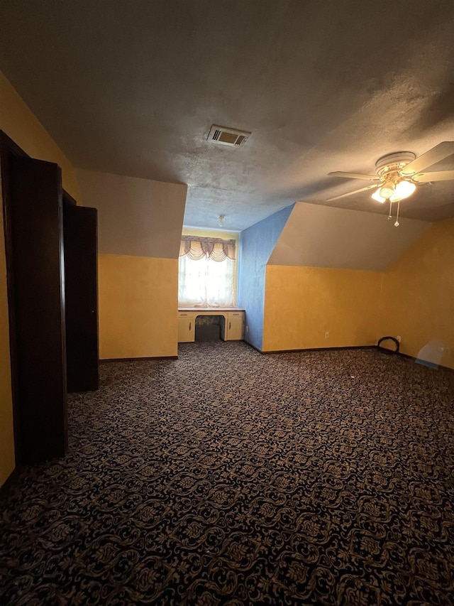 bonus room featuring a ceiling fan, carpet floors, and a textured ceiling