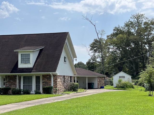 view of front of house with brick siding, a front lawn, and concrete driveway
