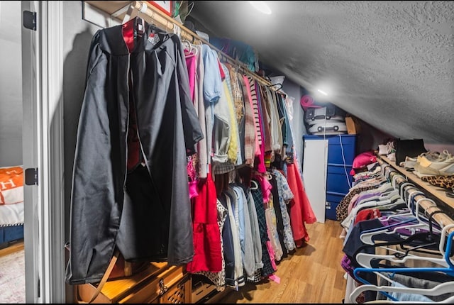 9655 Grapevine Dr, Orange, TX 77630 - spacious closet with vaulted ceiling and wood finished floors