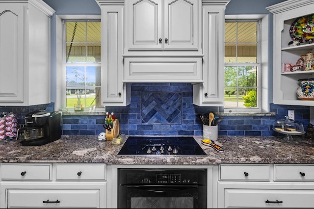 9655 Grapevine Dr, Orange, TX 77630 - kitchen featuring black appliances, white cabinetry, decorative backsplash, and dark stone countertops