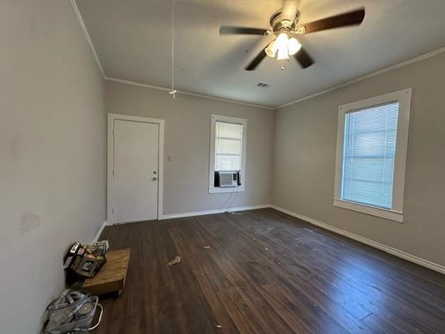 spare room with ceiling fan, ornamental molding, and dark wood-type flooring