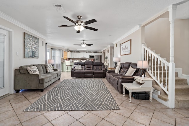 living room featuring crown molding, ceiling fan, and light tile patterned flooring