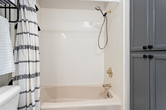 bathroom with shower / bath combo and toilet