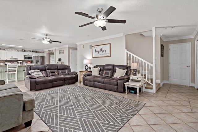 tiled living room featuring a textured ceiling, ceiling fan, and crown molding