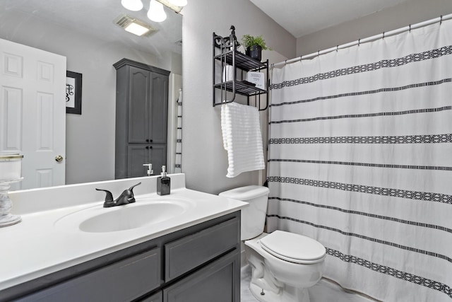 bathroom with vanity, toilet, and walk in shower