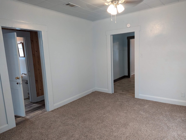 carpeted empty room with ceiling fan