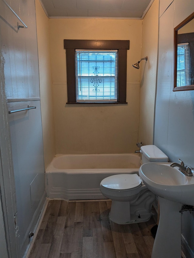 bathroom featuring hardwood / wood-style flooring, toilet, and shower / bathtub combination