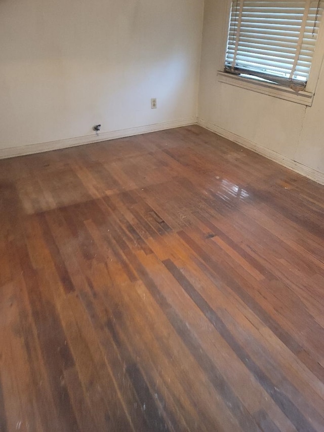 empty room featuring dark hardwood / wood-style flooring