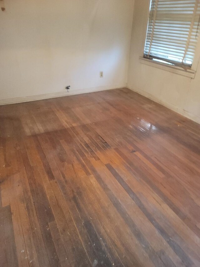 unfurnished room with dark hardwood / wood-style floors