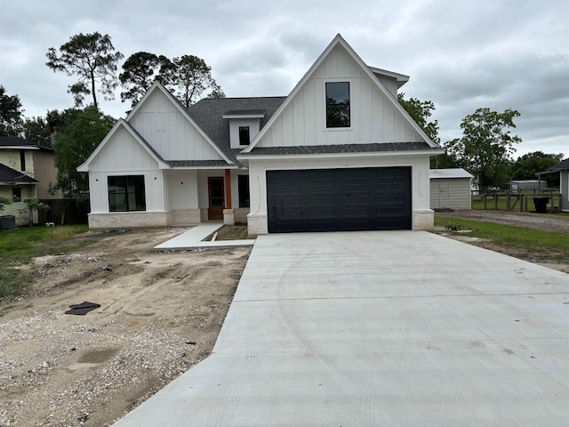 1107 N 22nd St, Nederland, TX 77627 - modern farmhouse style home featuring board and batten siding, driveway, an attached garage, a shingled roof, and brick siding
