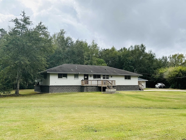 view of front of property with a deck and a front yard