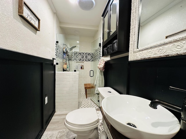 bathroom with walk in shower, ornamental molding, vanity, hardwood / wood-style floors, and toilet