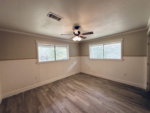 empty room with wood-type flooring, ceiling fan, and ornamental molding