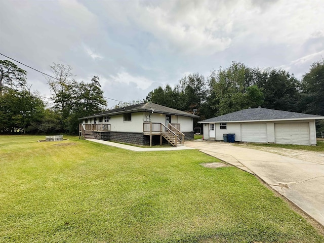 view of front of property with a deck, a front yard, and a garage