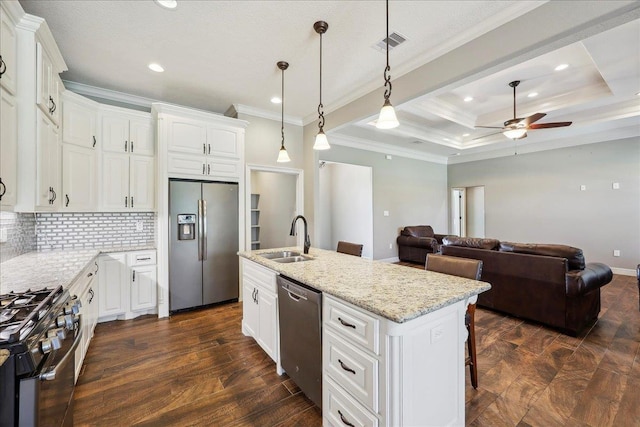 145 Colonial Estates Dr, Bridge City, TX 77611 - kitchen featuring stainless steel appliances, a sink, a ceiling fan, crown molding, and decorative backsplash