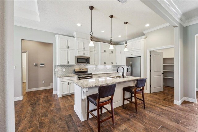 145 Colonial Estates Dr, Bridge City, TX 77611 - kitchen with appliances with stainless steel finishes, a sink, ornamental molding, baseboards, and tasteful backsplash
