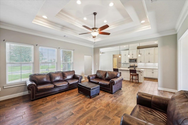 145 Colonial Estates Dr, Bridge City, TX 77611 - living room with a raised ceiling, dark wood-style flooring, plenty of natural light, crown molding, and recessed lighting