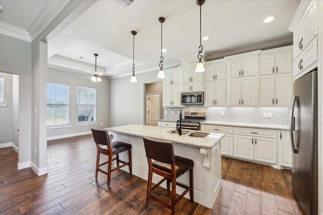 145 Colonial Estates Dr, Bridge City, TX 77611 - kitchen featuring stainless steel appliances, crown molding, tasteful backsplash, dark wood-type flooring, and baseboards