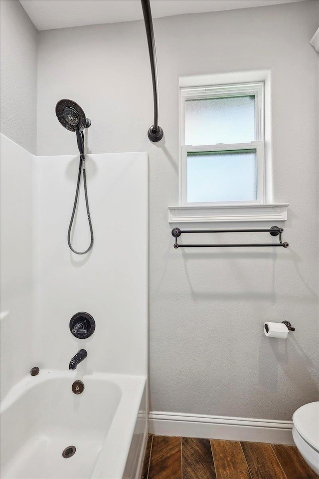 145 Colonial Estates Dr, Bridge City, TX 77611 - full bath with toilet, baseboards, shower / bath combination, and wood finished floors