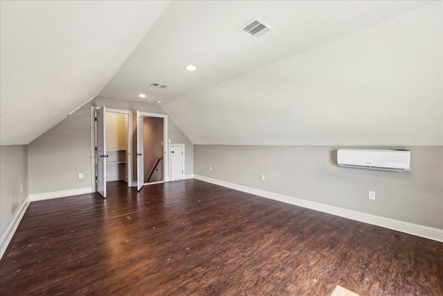 145 Colonial Estates Dr, Bridge City, TX 77611 - additional living space with a wall mounted air conditioner, wood finished floors, lofted ceiling, baseboards, and recessed lighting