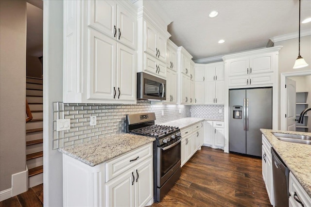 145 Colonial Estates Dr, Bridge City, TX 77611 - kitchen with stainless steel appliances, a sink, white cabinetry, recessed lighting, and ornamental molding