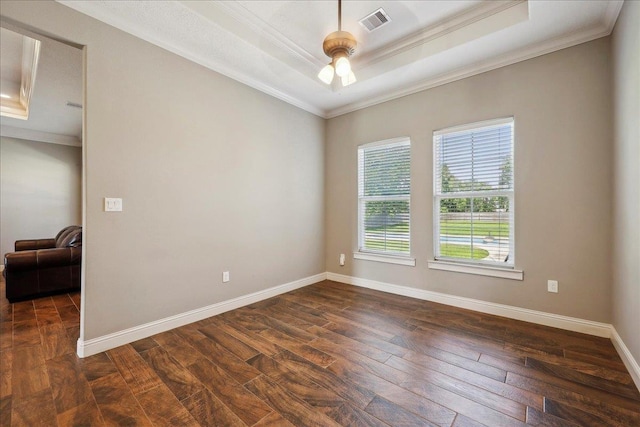 145 Colonial Estates Dr, Bridge City, TX 77611 - unfurnished room featuring ornamental molding, dark wood-style flooring, a tray ceiling, baseboards, and a ceiling fan