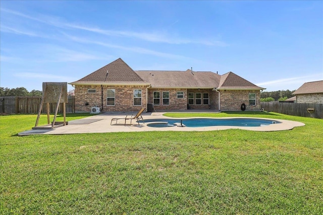145 Colonial Estates Dr, Bridge City, TX 77611 - rear view of property with a patio, a pool with connected hot tub, brick siding, and roof with shingles