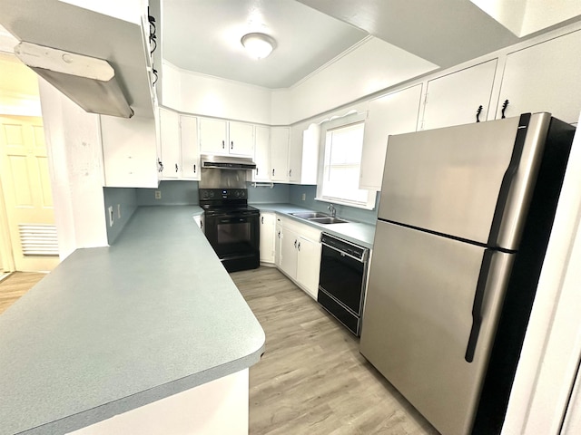 kitchen featuring sink, white cabinets, black appliances, and light wood-type flooring