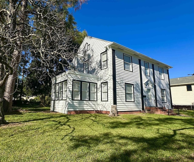 view of property exterior with a lawn