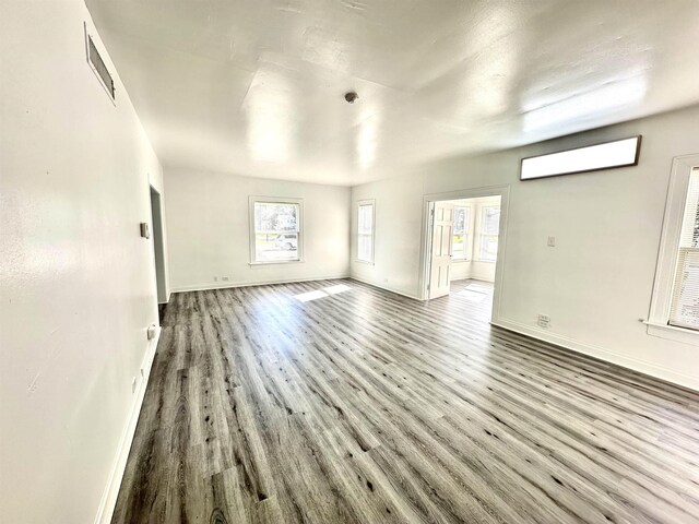 unfurnished living room featuring wood-type flooring