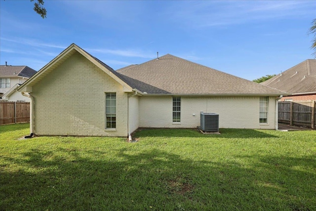 211 Skylark Ave, Bridge City, TX 77611 - rear view of house with brick siding, central air condition unit, and a shingled roof