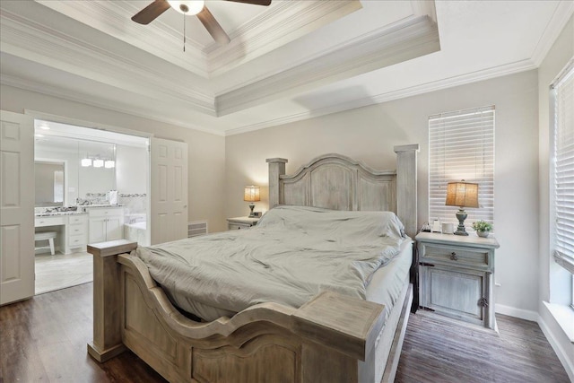 211 Skylark Ave, Bridge City, TX 77611 - bedroom with a raised ceiling, crown molding, dark wood finished floors, ensuite bath, and a ceiling fan