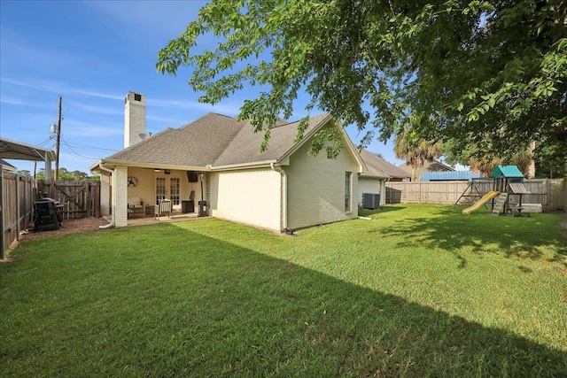 211 Skylark Ave, Bridge City, TX 77611 - rear view of house with french doors, a chimney, a playground, a patio area, and cooling unit