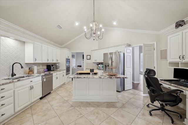 211 Skylark Ave, Bridge City, TX 77611 - kitchen with stainless steel appliances, a sink, a center island, white cabinetry, and a chandelier