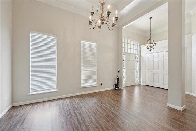 211 Skylark Ave, Bridge City, TX 77611 - foyer entrance featuring a chandelier, wood finished floors, crown molding, baseboards, and a high ceiling