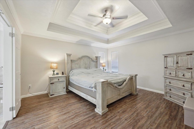 211 Skylark Ave, Bridge City, TX 77611 - bedroom featuring dark wood-style floors, baseboards, a raised ceiling, ornamental molding, and a ceiling fan