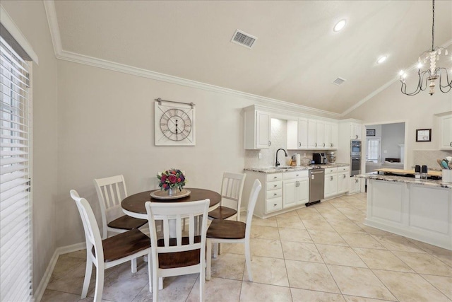 211 Skylark Ave, Bridge City, TX 77611 - dining room featuring a chandelier, ornamental molding, healthy amount of natural light, and high vaulted ceiling