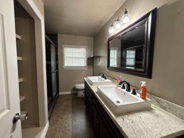 4400 Bethany St, Port Arthur, TX 77642 - bathroom featuring toilet, double vanity, a shower stall, and baseboards