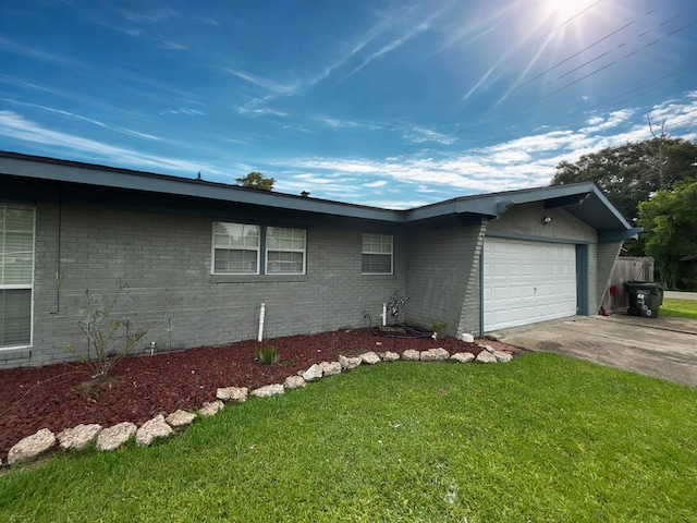 4400 Bethany St, Port Arthur, TX 77642 - view of home's exterior with a lawn, an attached garage, concrete driveway, and brick siding